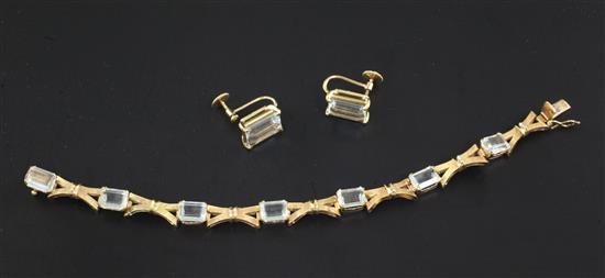 A gold and aquamarine bracelet set with seven emerald cut stones and a pair of similar 9ct earrings, bracelet 6.5in.